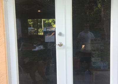 Tinted impact windows with white frame